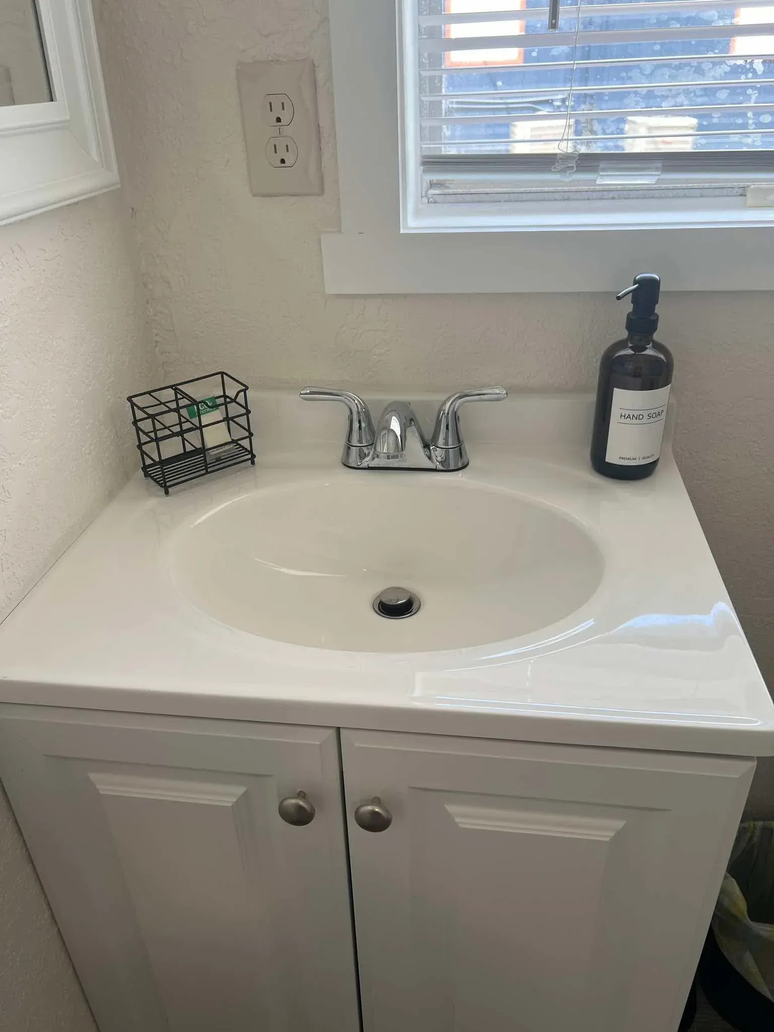 Clean bathroom vanity and sink after deep clean
