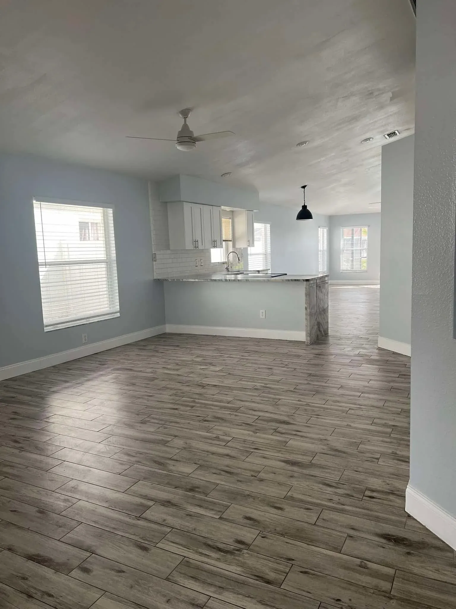 Open plan home cleaned for move-out, spotless floors and kitchen area